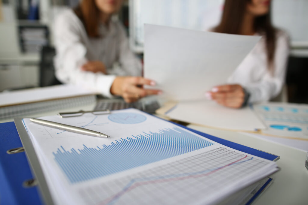 Pen lie on blue financial statistic analysis chart