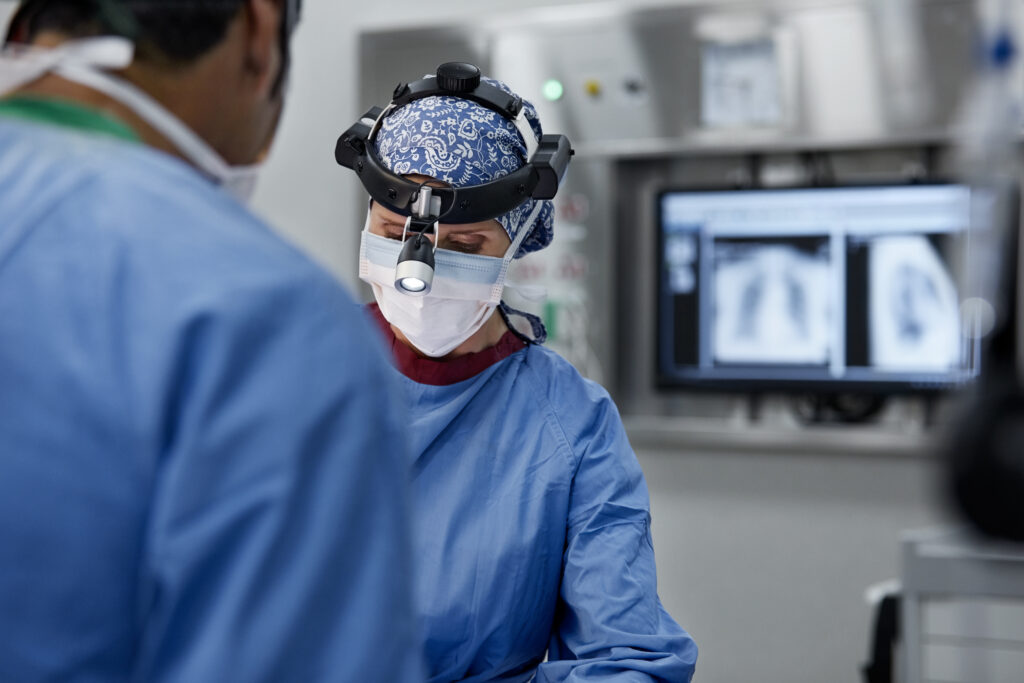 Female surgeon wearing headlamp in emergency room