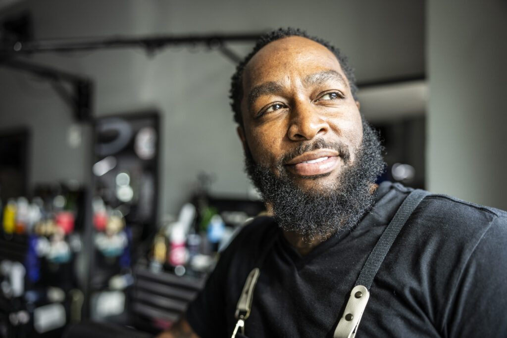 Portrait of proud barbershop owner in his shop
